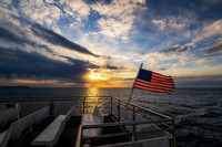 Sunset from the ferry with flag