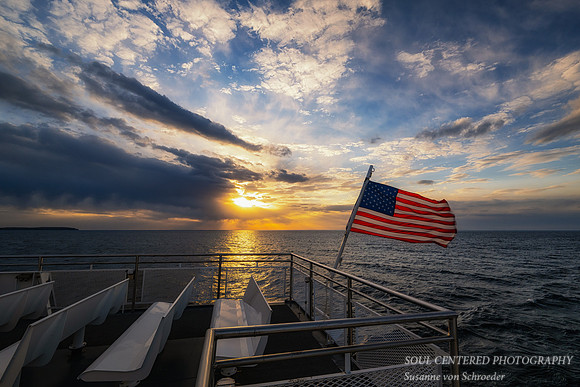 Sunset from the ferry with flag