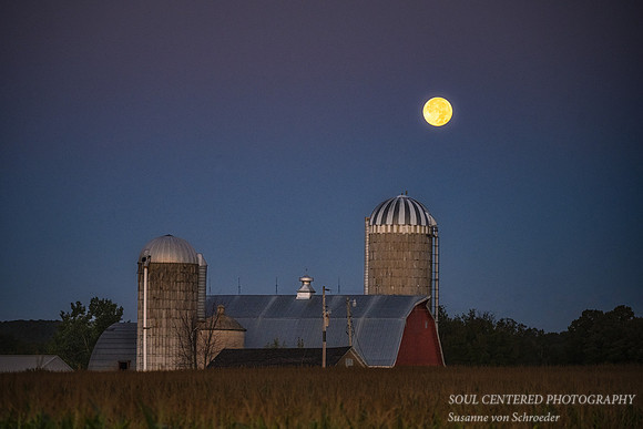 Super Blue Full moon setting behind a barn, Aug. '23