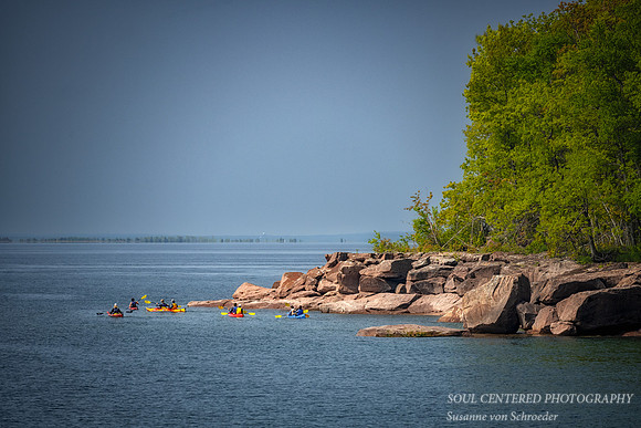 Kayakers along the rocks on Madeline Island