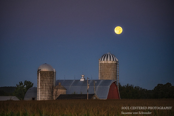 Super Blue Full moon setting behind a barn, Aug. '23