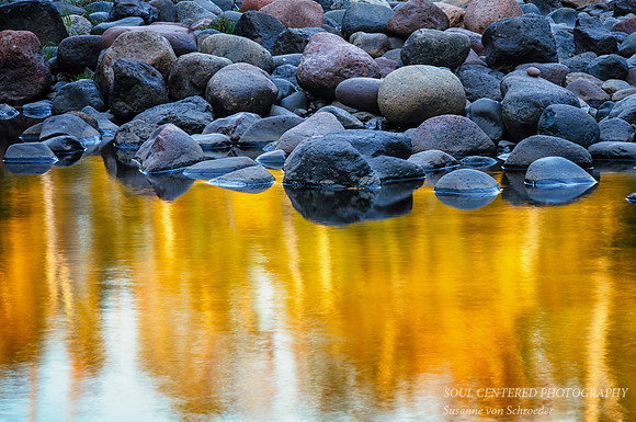 Water golden, blue rocks