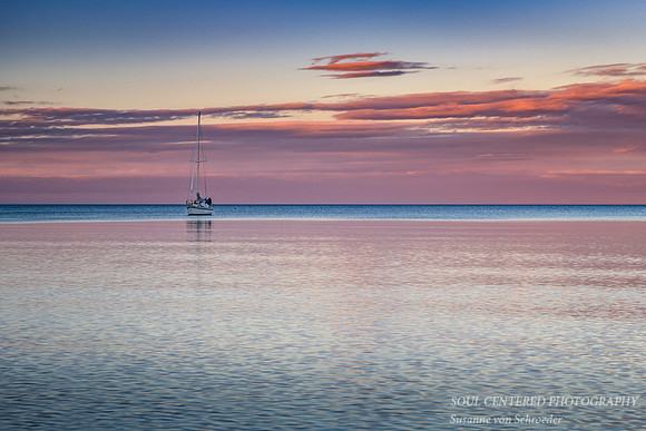 Sunset colors with sailboat