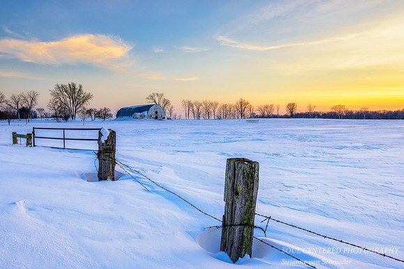 Winter sunset, fence and barn